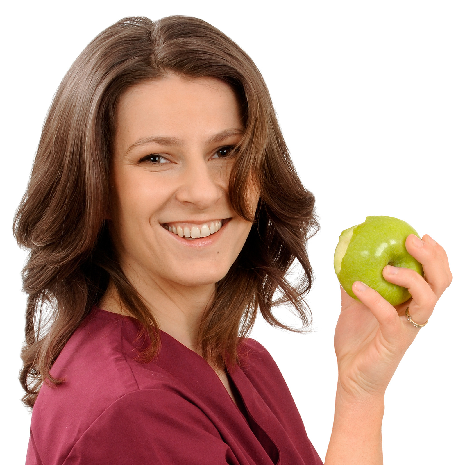 Judith Ehrich hält einen angebissenen Apfel in der Zentrum für Zahnmedizin.